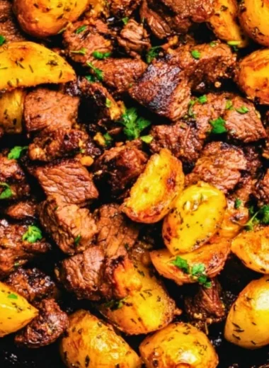 Butter steak bites served with garlic herb potatoes on a plate.
