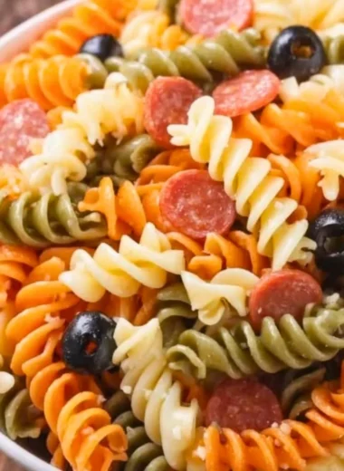 A colorful bowl of easy and delicious Italian pasta salad with fresh vegetables.