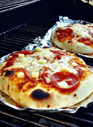 Delicious grilled pizza on a barbecue grill with fresh toppings.