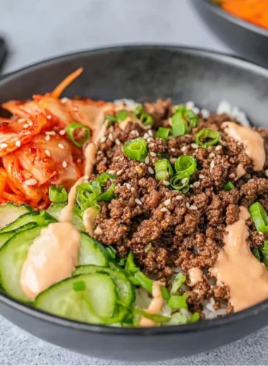 Korean beef rice bowl topped with sesame seeds and green onions