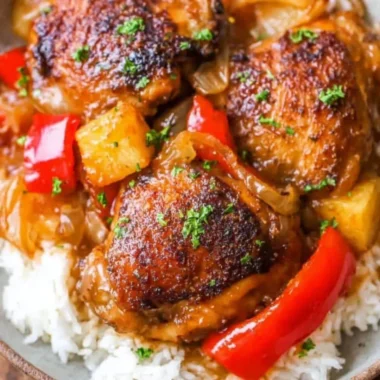 Delicious Slow Cooker Hawaiian Pineapple Chicken served with rice and vegetables