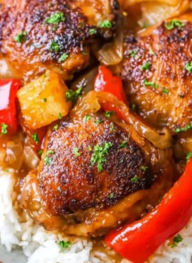 Delicious Slow Cooker Hawaiian Pineapple Chicken served with rice and vegetables