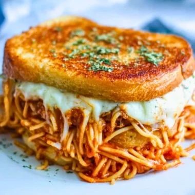 Delicious spaghetti grilled cheese sandwich prepared with gooey melted cheese.