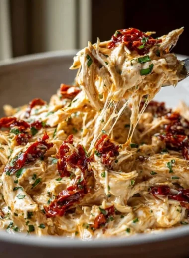Creamy Crockpot Marry Me Chicken recipe served on a plate with herbs