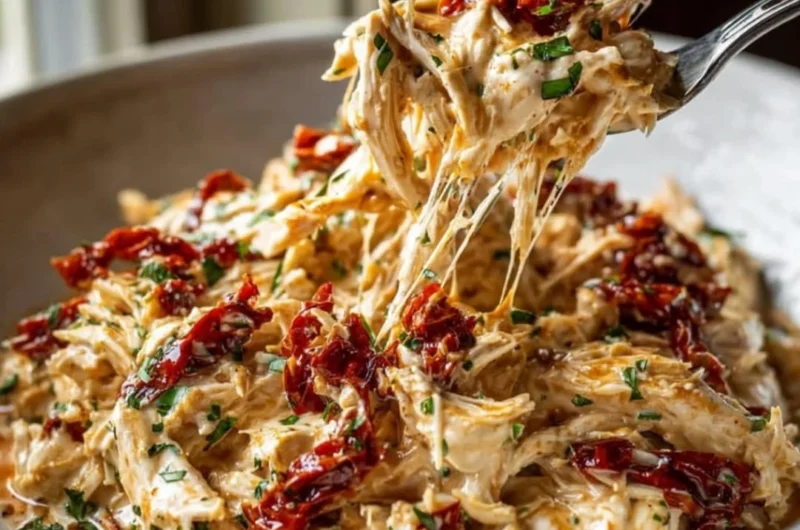 Creamy Crockpot Marry Me Chicken recipe served on a plate with herbs