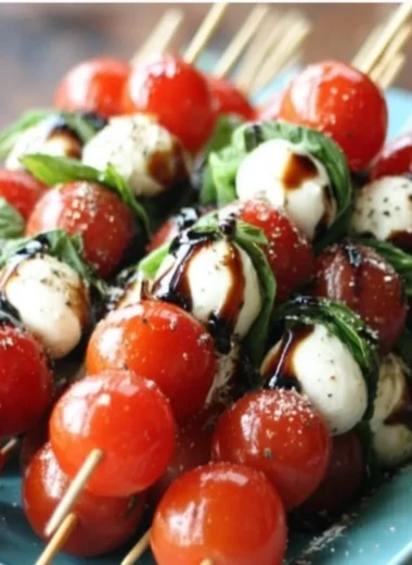 Delicious Caprese Salad Skewers with tomatoes, mozzarella, and basil arranged on a platter.