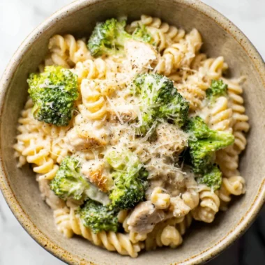 Delicious Chicken Broccoli Pasta served with cream sauce and fresh herbs.