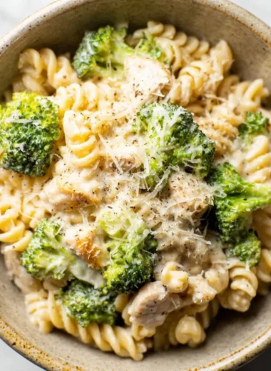Delicious Chicken Broccoli Pasta served with cream sauce and fresh herbs.