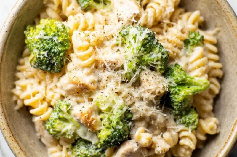 Delicious Chicken Broccoli Pasta served with cream sauce and fresh herbs.