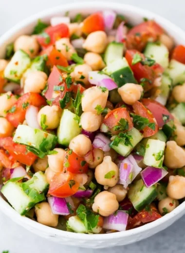 Delicious chickpea salad with fresh vegetables and dressing