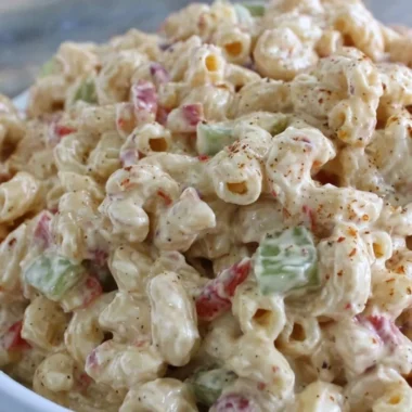 Creamy macaroni salad served in a bowl, perfect for summer picnics and gatherings.