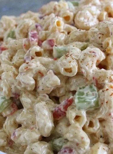 Creamy macaroni salad served in a bowl, perfect for summer picnics and gatherings.