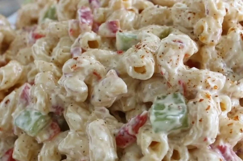 Creamy macaroni salad served in a bowl, perfect for summer picnics and gatherings.