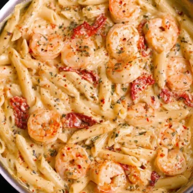 Creamy shrimp pasta served in a bowl with herbs and spices for a delicious meal.