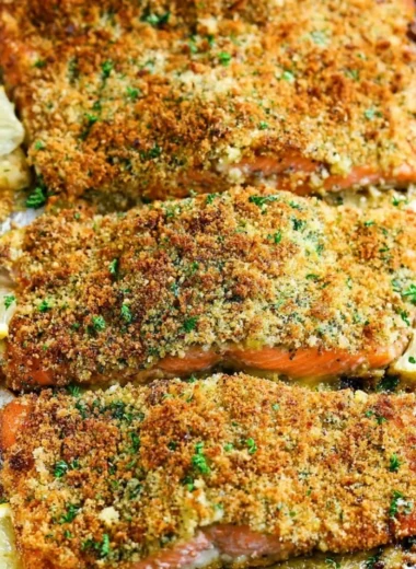 Crispy garlic parmesan salmon garnished with herbs on a plate