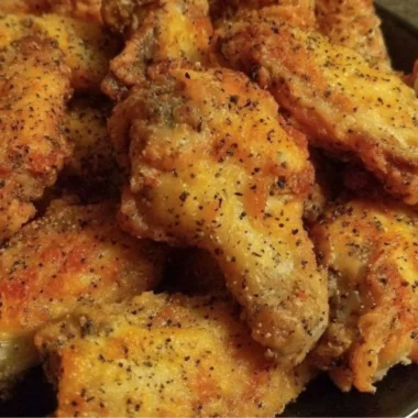 Easy lemon pepper chicken wings served on a platter with dipping sauce