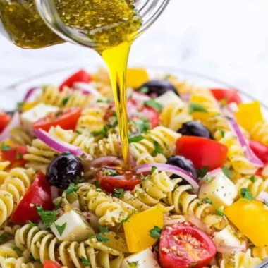 Bowl of homemade Italian dressing with fresh herbs and spices