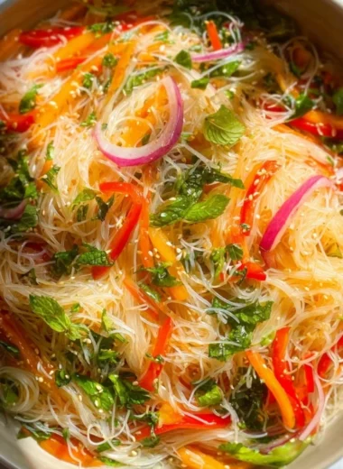 Colorful no cook noodle salad topped with tangy dressing and fresh vegetables.