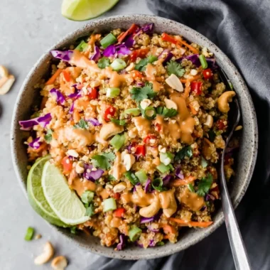 Thai-inspired quinoa salad with creamy peanut ginger dressing on a plate.