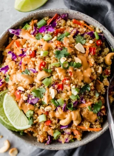 Thai-inspired quinoa salad with creamy peanut ginger dressing on a plate.