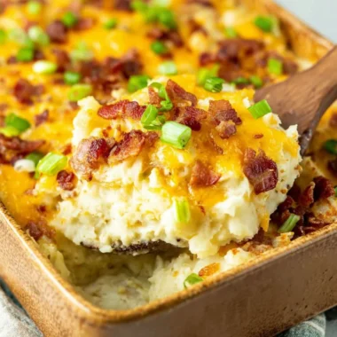 Delicious Twice Baked Potato Casserole topped with cheese and bacon