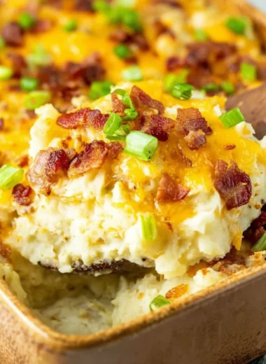 Delicious Twice Baked Potato Casserole topped with cheese and bacon