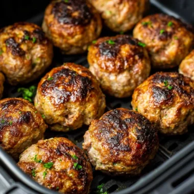 Delicious air fryer meatballs served with marinara sauce and fresh herbs