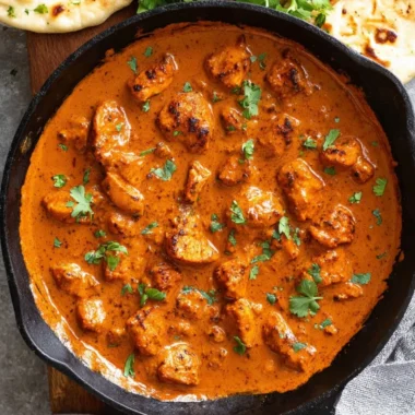 Delicious Chicken Tikka Masala served with rice and naan bread