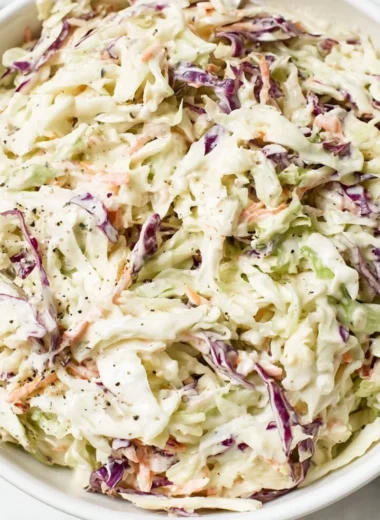 Bowl of fresh coleslaw with shredded cabbage and carrots