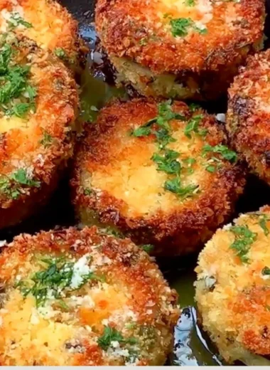 Plate of crispy breaded eggplant garnished with herbs