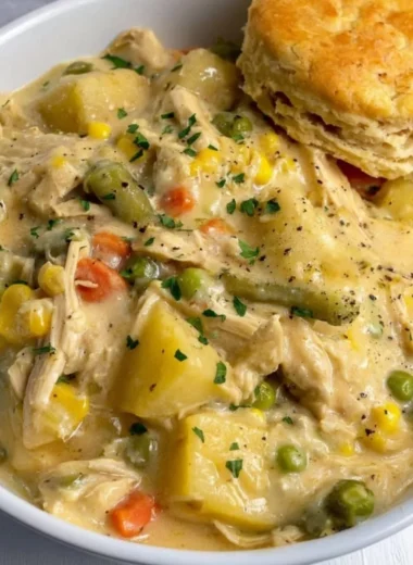 Delicious Crock Pot Chicken Pot Pie served in a bowl with fresh herbs