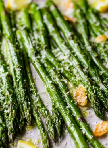 Oven roasted Garlic Parmesan asparagus on a plate garnished with parsley.