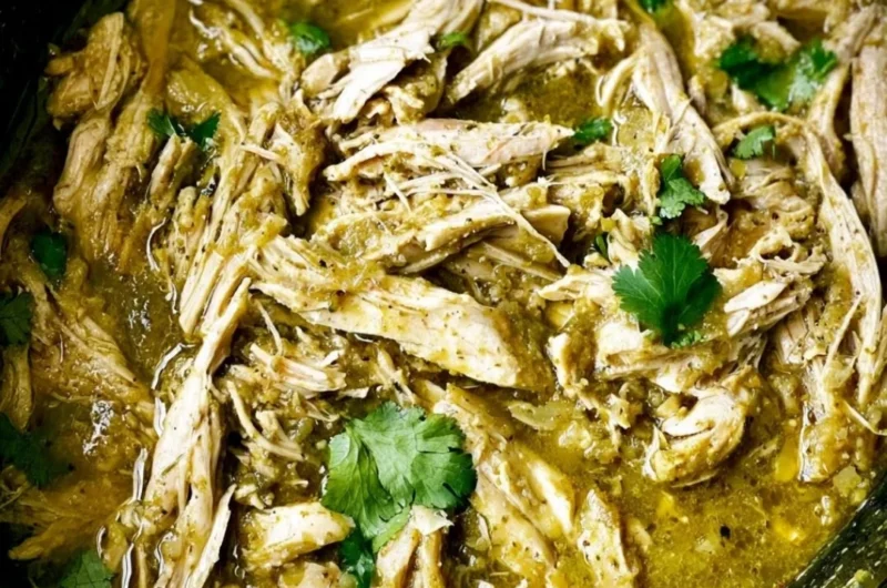 Slow cooker chicken with green sauce garnished with fresh herbs