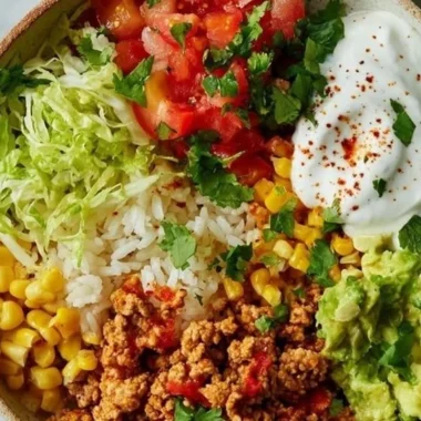 Healthy turkey taco bowl with fresh vegetables and spices