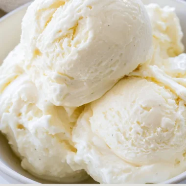 Delicious no-churn ice cream in a bowl topped with fresh strawberries