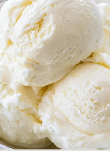 Delicious no-churn ice cream in a bowl topped with fresh strawberries