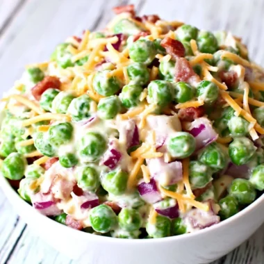 Delicious pea salad with fresh peas, herbs, and dressing served in a bowl.