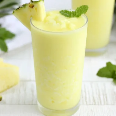 A refreshing Pineapple Rum Slush in a glass, perfect for summer cocktails.