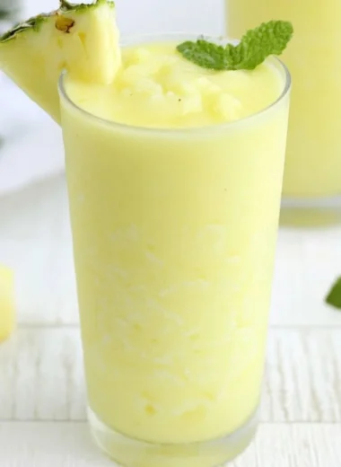 A refreshing Pineapple Rum Slush in a glass, perfect for summer cocktails.