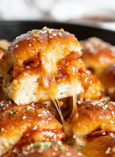 Delicious pizza sliders with toppings on a wooden platter