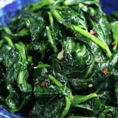 Plate of quick and easy sautéed spinach cooked with garlic and olive oil