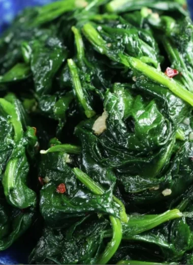 Plate of quick and easy sautéed spinach cooked with garlic and olive oil
