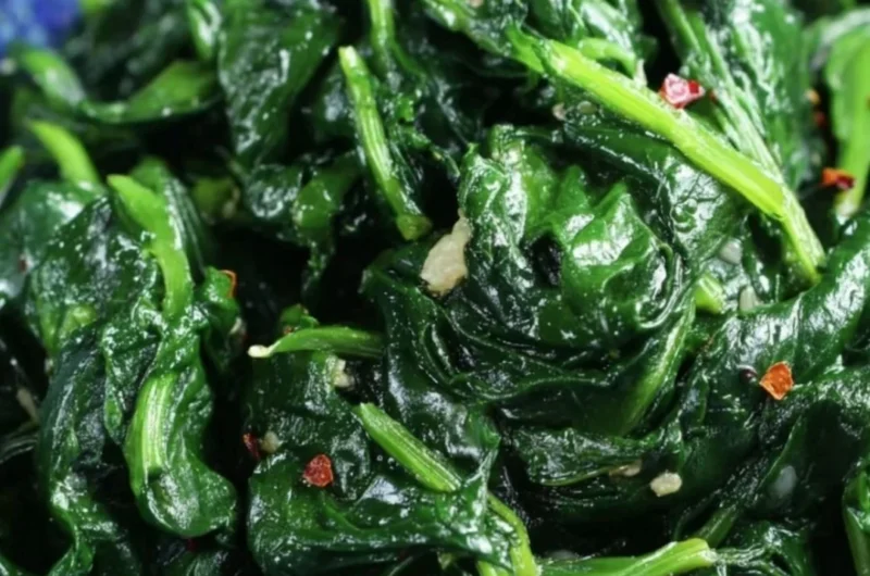 Plate of quick and easy sautéed spinach cooked with garlic and olive oil