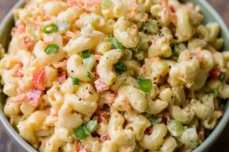 Bowl of delicious small homemade macaroni salad with fresh vegetables and dressing