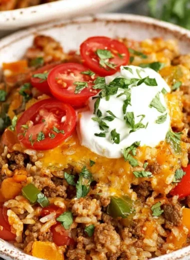 Delicious stuffed pepper casserole with bell peppers, rice, and ground beef.