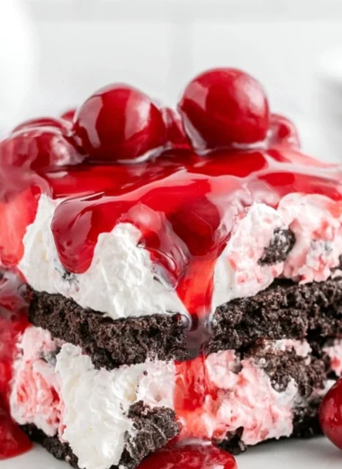 Homemade Black Forest Icebox Cake topped with cherries and whipped cream