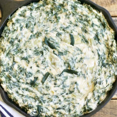 Creamy spinach artichoke dip served with crispy tortilla chips