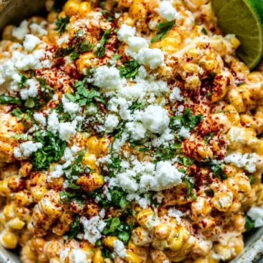 Creamy and flavorful Mexican street corn (elote) served on a cob