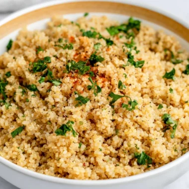 Delicious Garlic Butter Quinoa served in a bowl with fresh herbs.