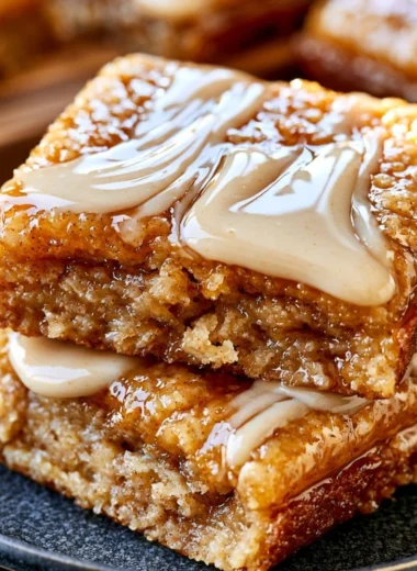 Deliciously soft baked maple donut bars on a rustic wooden table